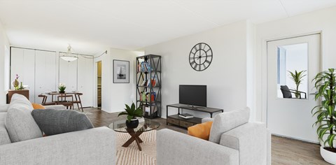 a living room with white walls and a glass coffee table at The Ivanhoe Apartments, Hackensack, NJ